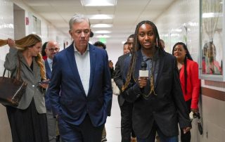 Governor Ned Lamont is peaking with Senior Hailey Archer, a Digital media student.